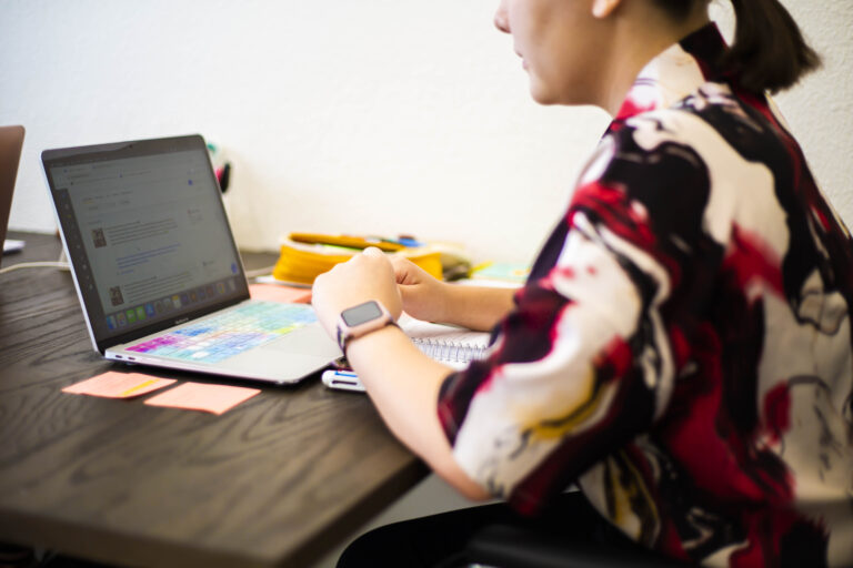 Gova Creative designer reviewing a website redesign on a laptop