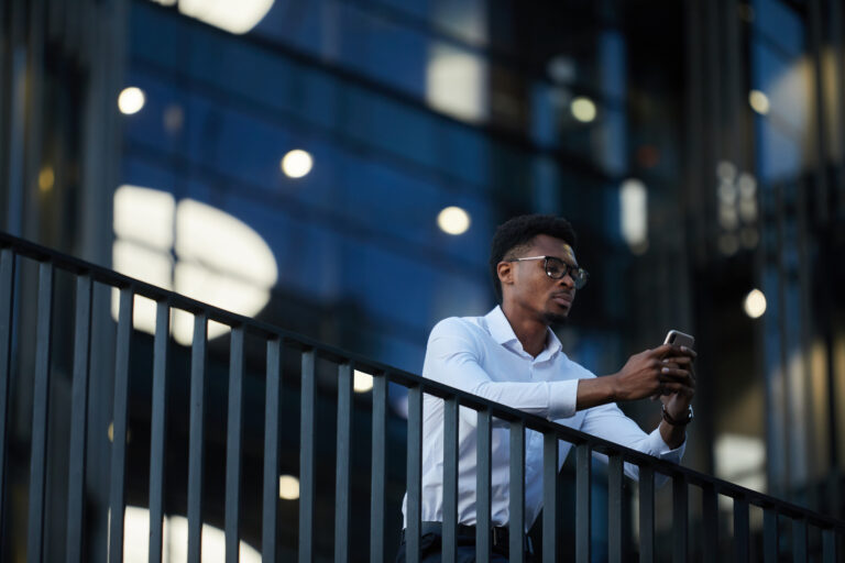 Businessman on his phone, showing how digital marketing shapes buying decisions