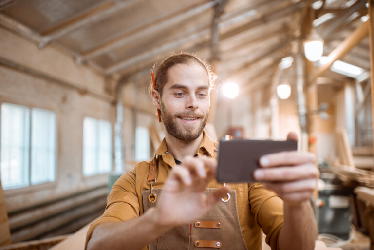 Male scrolling through social media while planning digital marketing