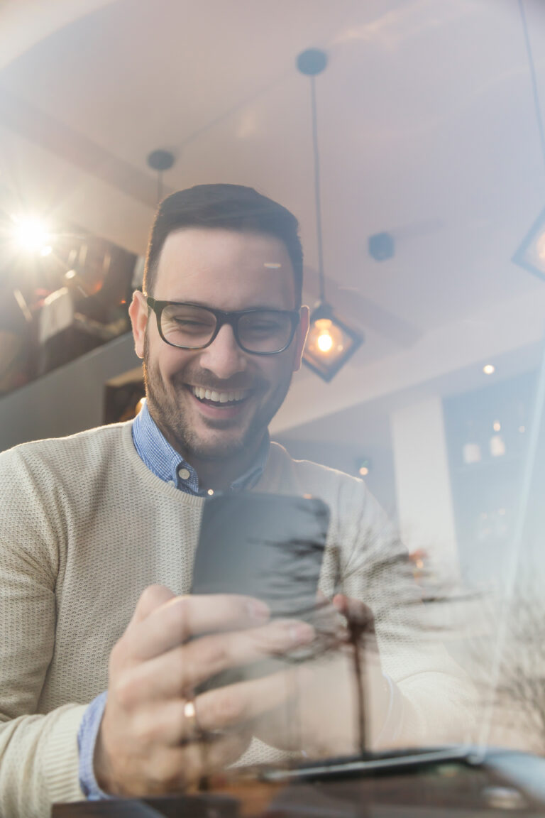 Male using his phone to read digital marketing content