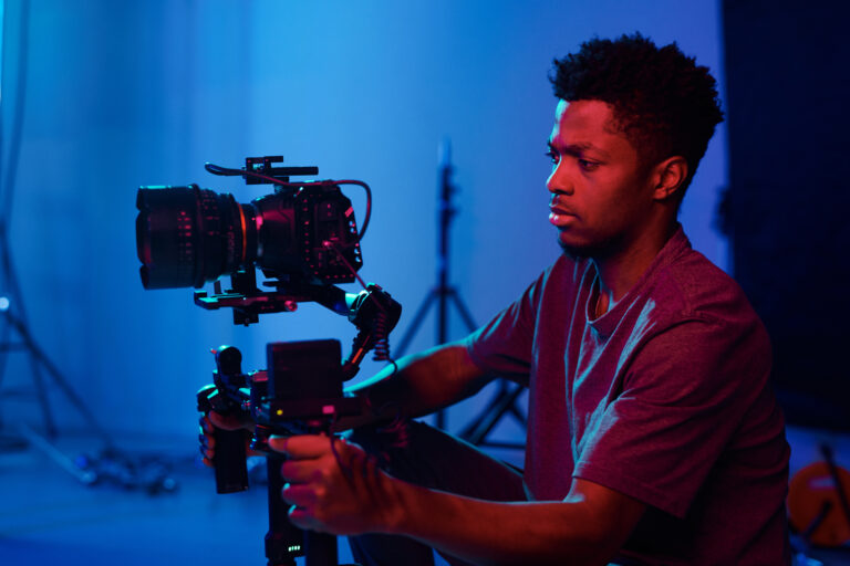 Male holding a camera during a video production shoot