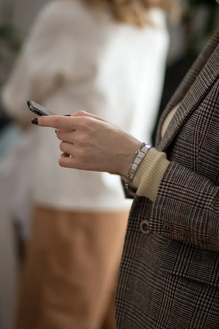 Person on their phone searching Google, where SEO title tags appear