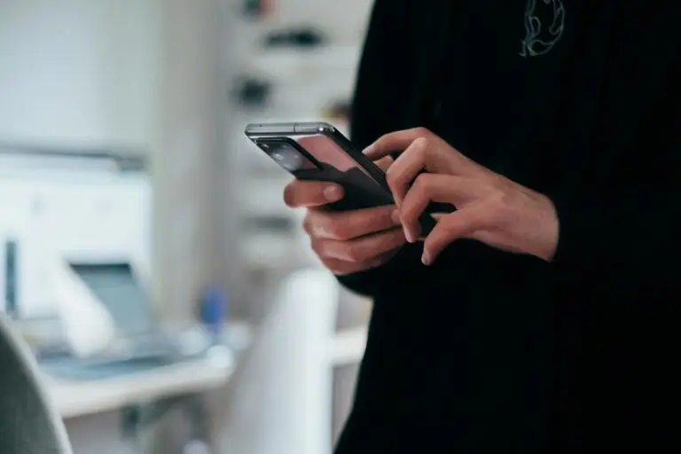 Person on their phone searching Google and reading SEO meta descriptions