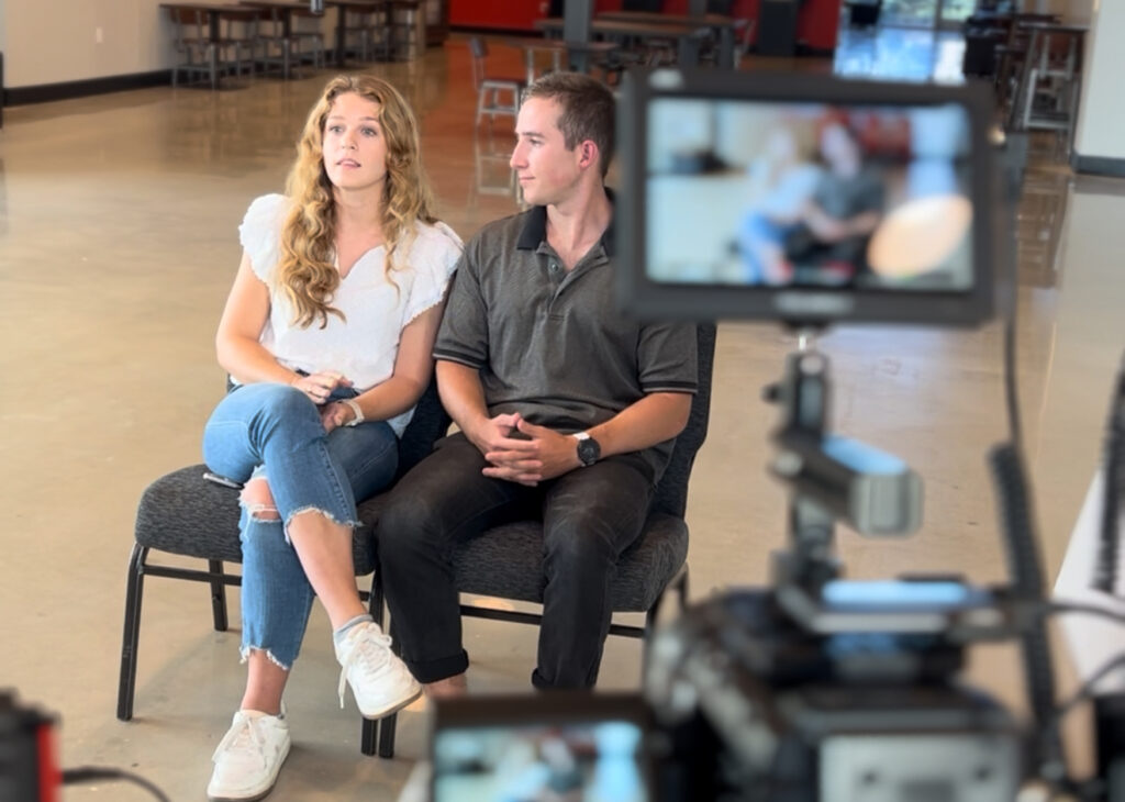 A couple on a video production shoot filming a video for a local organization.