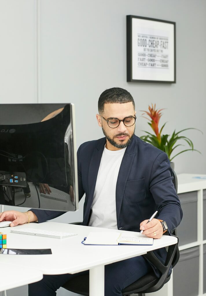 Man on computer trying to figure out the cost of SEO