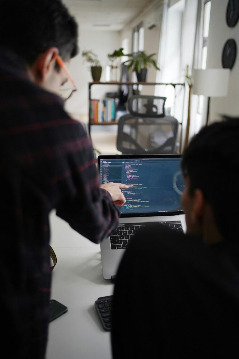 Small team planning an SEO strategy around a laptop